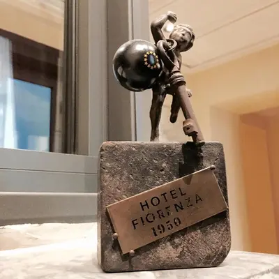 a statue of a man on top of a hotel sign at Hotel Fiorenza in Rome