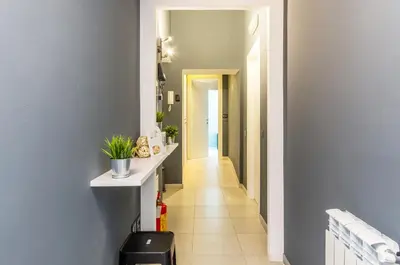a hallway of a home with blue walls and a white counter at Merulana 139 Suites in Rome