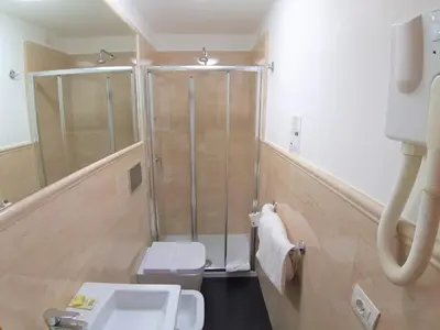 a bathroom with a shower and a toilet and a sink at Colosseo Roma in Rome