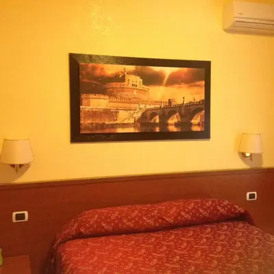 a painting on the wall above a bed in a bedroom at Residenza Fermi in Rome