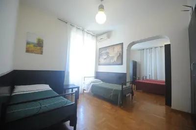 a bedroom with two beds and a mirror at Hotel Beauty in Rome
