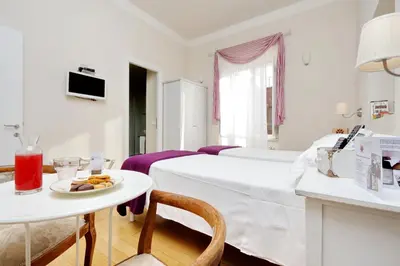 a white room with a bed and a table with a plate of food at Guest House Amaranto Romano in Rome