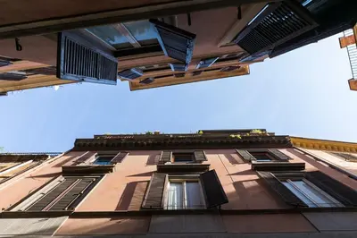 a tall building with windows on the side of it at Delle Grotte Apartment in Rome
