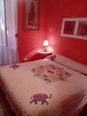 a bedroom with a bed with a patterned blanket on it at Max House in Rome