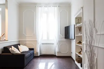 a living room with a couch and a television at Frattina Royal in Rome