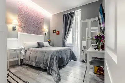 a small bedroom with a bed and a mirror at Bed And Best in Rome