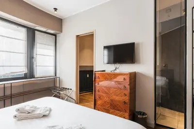 a bedroom with a bed and a flat screen tv at The Place in Rome