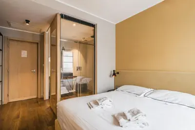 a bedroom with a large white bed and a mirror at The Place in Rome