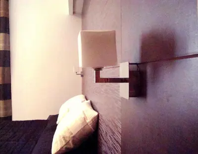 a room with a bed with a lamp on the wall at Interno 5 B&B in Rome