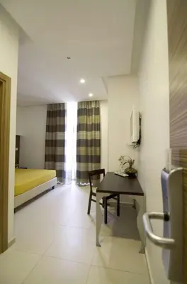 a room with a table and a bed and a room at Interno 5 B&B in Rome