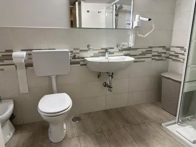 a bathroom with a toilet and a sink at Casa Vacanza Vahid in Rome