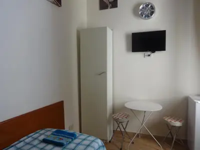 a bedroom with a bed and a tv on the wall at B&B Twins in Rome