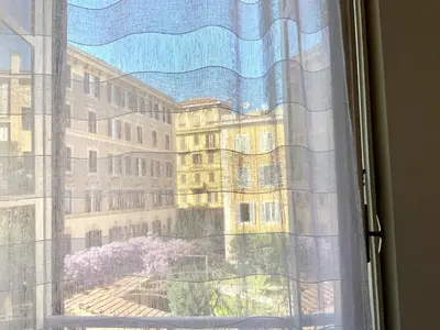 a window with a view of a building at Le Rondini a Roma in Rome