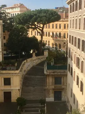 a stairway leading up to a building with a tree at Le Rondini a Roma in Rome