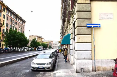 a white car parked on the side of a street at Le Rondini a Roma in Rome