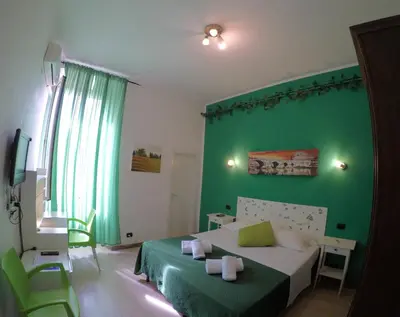 a green bedroom with a bed and a green wall at Julius Caesar 183 in Rome