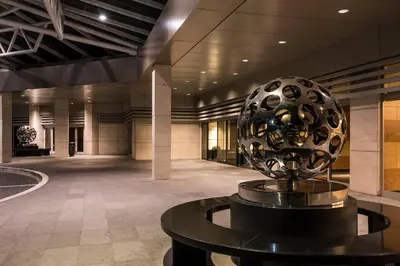 a large metal ball on a table in a lobby at Ergife Palace Hotel in Rome