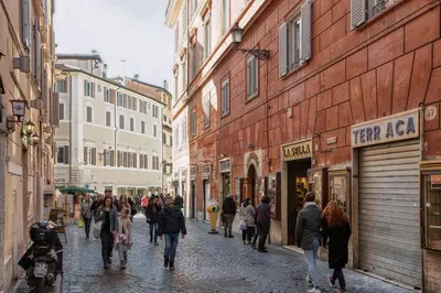 a group of people walking down a street with buildings at BQ House Trevi Luxury Rooms in Rome