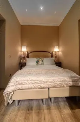 a bedroom with a large bed with two lamps at BQ House Trevi Luxury Rooms in Rome