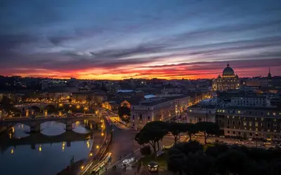 a view of a city at night with a bridge at Casa Camilla in Rome