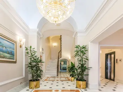 a large hallway with a chandelier and plants at Raeli Hotel Floridia in Rome