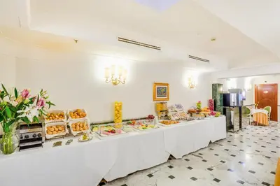 a buffet line with plates of food on it at Raeli Hotel Regio in Rome