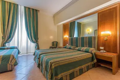 a hotel room with a bed and a mirror at Raeli Hotel Archimede in Rome