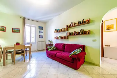 a living room with a red couch and a table at Apartment Angelo Emo 69 in Rome