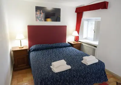 a bedroom with a bed with two towels on it at Farnese 48 in Rome