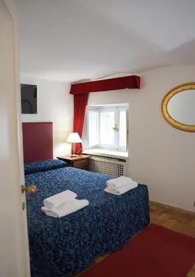 two beds in a hotel room with towels on them at Farnese 48 in Rome
