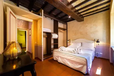 a bedroom with a large bed and a table at maison specchi in Rome