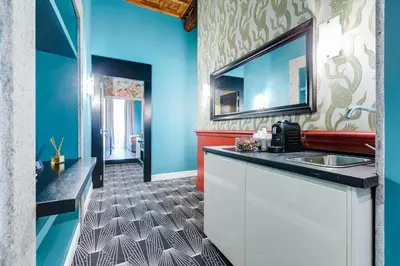 a bathroom with a sink and blue walls at The French suites by oneup Hospitality in Rome