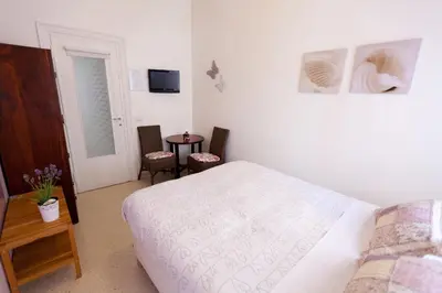 a bedroom with a bed and a table with chairs at Marco Polo Vatican APARTMENT Metro A 2 min - San Pietro 10 min in Rome