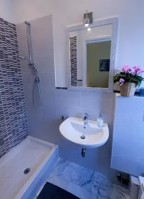 a bathroom with a sink and a mirror and a tub at Marco Polo Vatican APARTMENT Metro A 2 min - San Pietro 10 min in Rome
