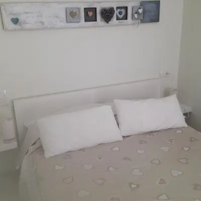 a white bed with two pillows on top of it at flaminio heart house in Rome