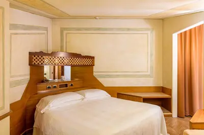 a bedroom with a bed and a mirror at Hotel S. Anna in Rome