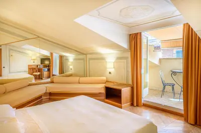 a hotel room with two beds and a window at Hotel S. Anna in Rome