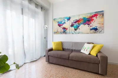 a living room with a couch and a painting at Enjoy Porta Furba in Rome