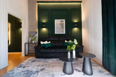 a living room with a black couch and a table at colosseo flats and penthouse in Rome