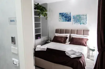 a bedroom with a large bed with towels on it at Il Magnificus Boutique in Rome