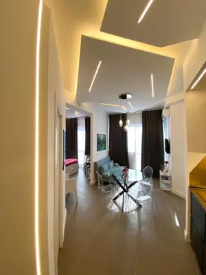a living room with a couch and a table at La Maison, vicino al Colosseo! in Rome