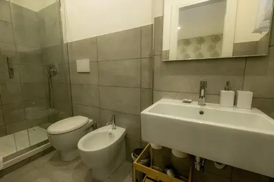 a bathroom with a sink and a toilet and a mirror at Suite Pinturicchio in Rome