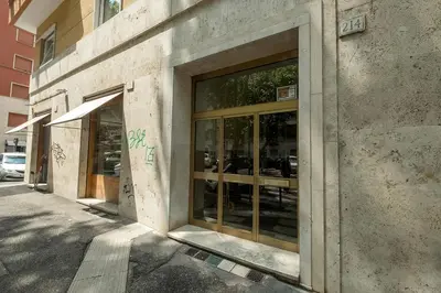 a building with glass doors on the side of a street at Suite Pinturicchio in Rome