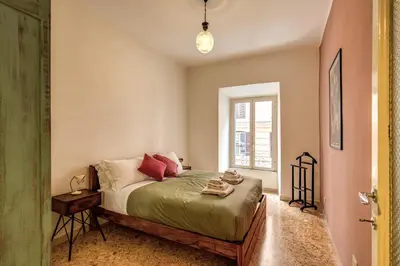 a bedroom with a bed and a window at Trastevere San Cosimato vintage in Rome
