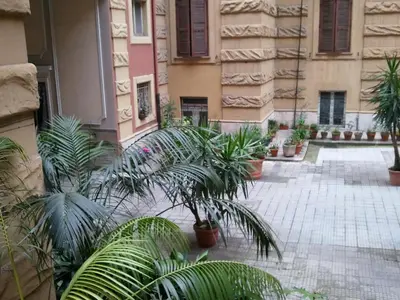 a courtyard with potted plants in a building at ISABEL Guest House in Rome