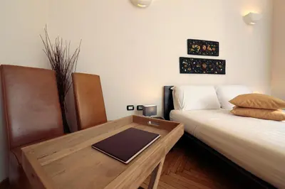 a room with a bed and a table with a laptop on it at Residenza Delle Arti in Rome