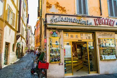 a bike parked in front of a store on a street at H-Aviva Giubbonari Apartment in Rome