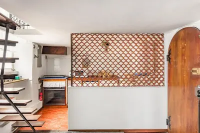 a kitchen with a white refrigerator in a room at Trastevere Alley Apartment in Rome