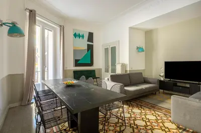 a living room with a table and a couch at ROMAC Mazzini with 5 bedrooms near the Vatican in Rome