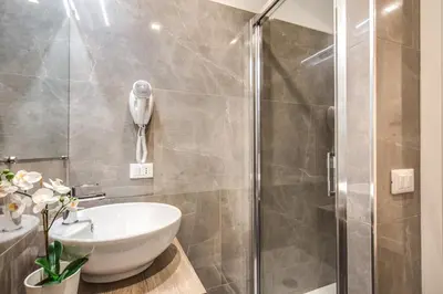 a bathroom with a sink and a shower at River Luxury Suites in Rome